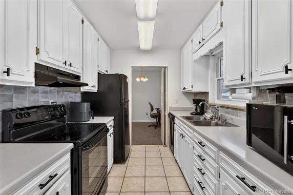 a kitchen with stainless steel appliances granite countertop a stove refrigerator sink and cabinets