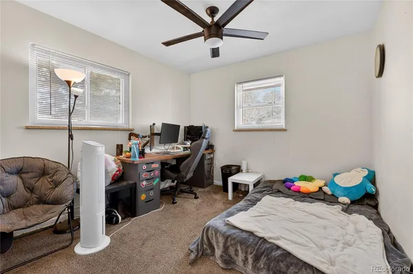 a bedroom with a bed and wall painting