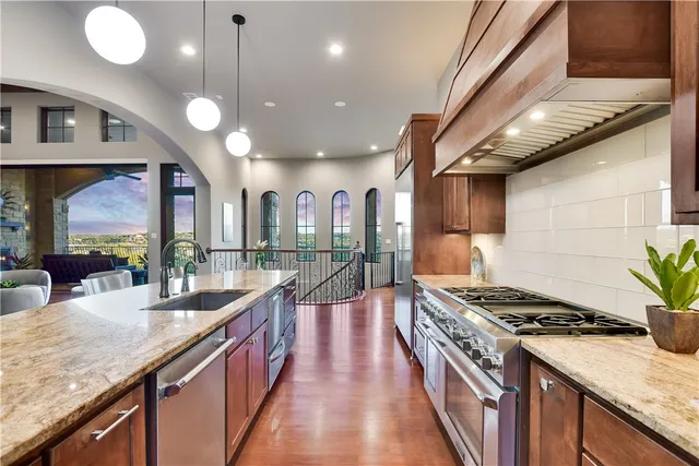 a kitchen with stainless steel appliances granite countertop counter space a sink and cabinets