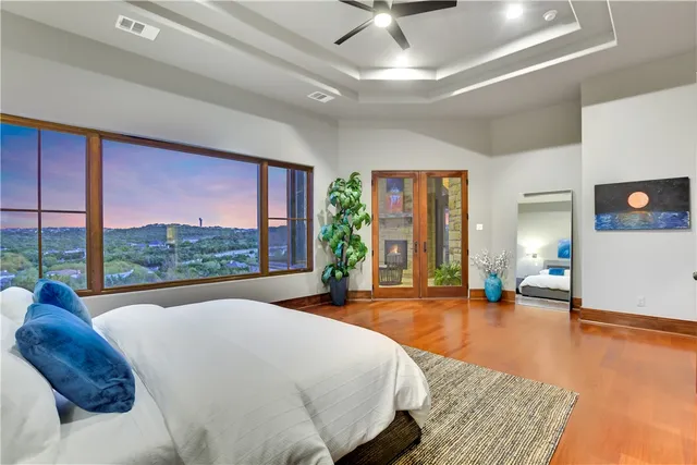 a spacious bedroom with a large bed and a large window