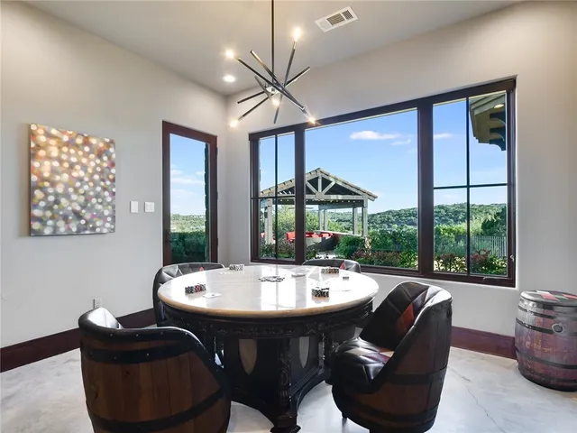 a room with furniture a large window and a chandelier