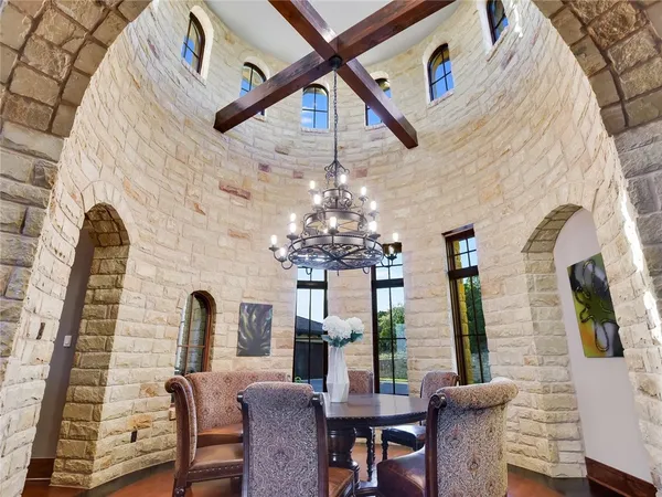 a view of a dining room with furniture and a chandelier