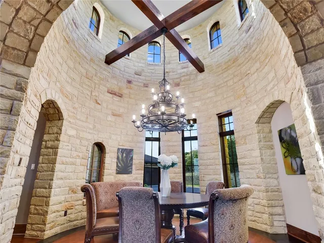 a view of a dining room with furniture and a chandelier