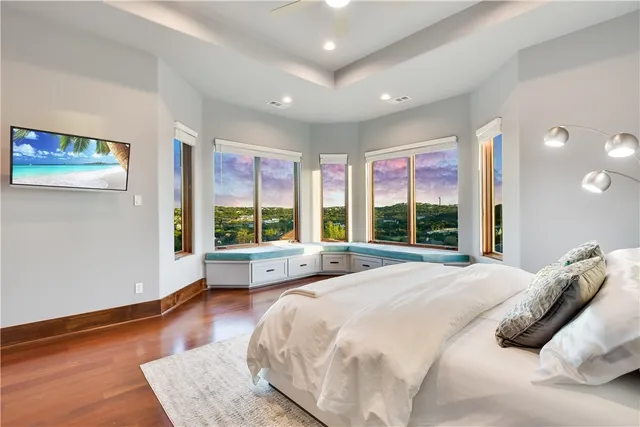 a spacious bedroom with a large bed and a large window