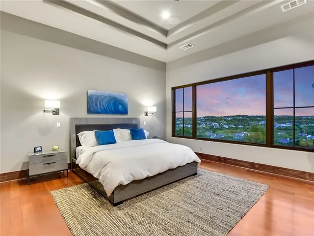 a bedroom with a large bed and a large window