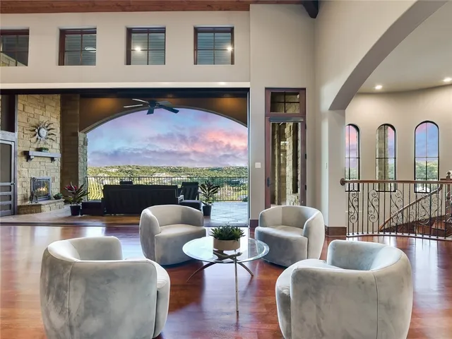 a living room with furniture and a floor to ceiling window