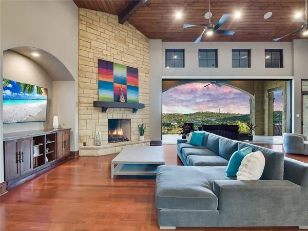 a living room with fireplace furniture and a flat screen tv