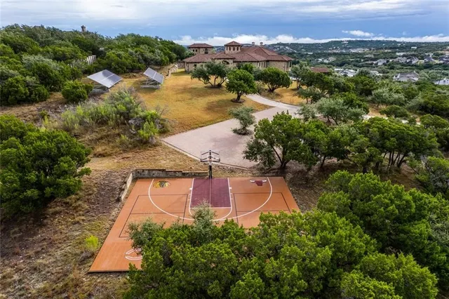 an aerial view of residential houses with outdoor space and lake view