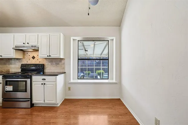 a kitchen with a stove a sink and a microwave