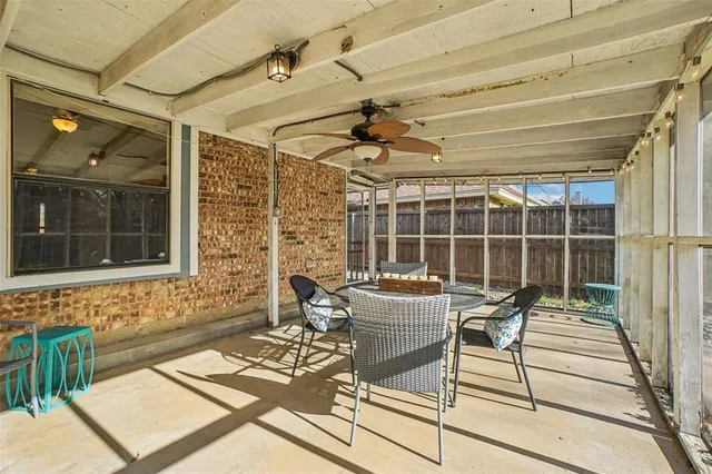 a view of a patio with table and chairs and potted plants