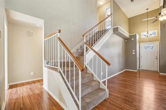 a view of entryway and hall with wooden floor