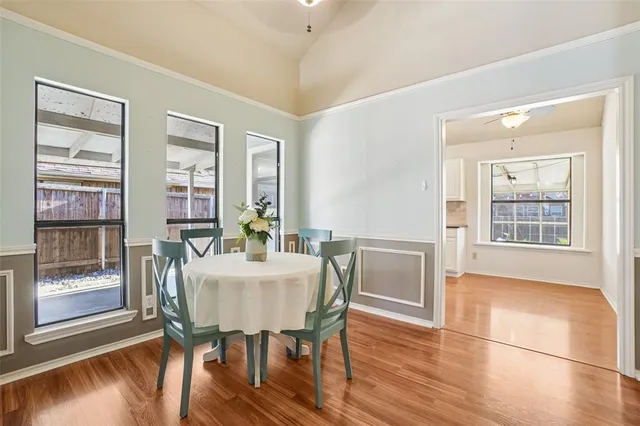 a view of a dining room with furniture wooden floor and a chandelier