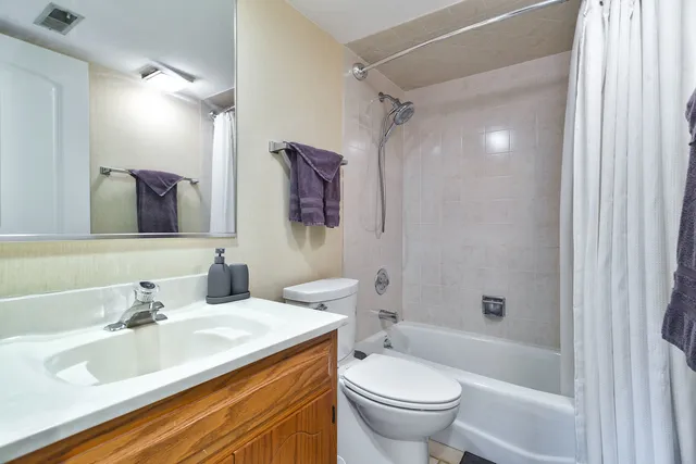 a bathroom with a sink toilet tub and shower