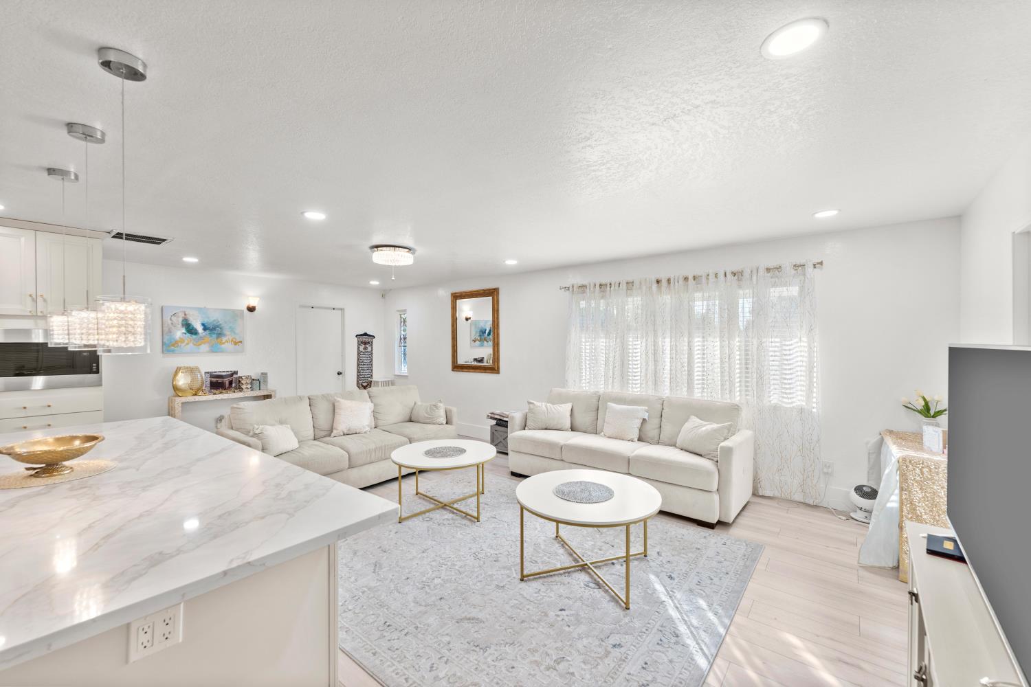 8850 Bader Road Elk Grove, CA 95624 - Photo 13 of 43 a living room with furniture and a large window