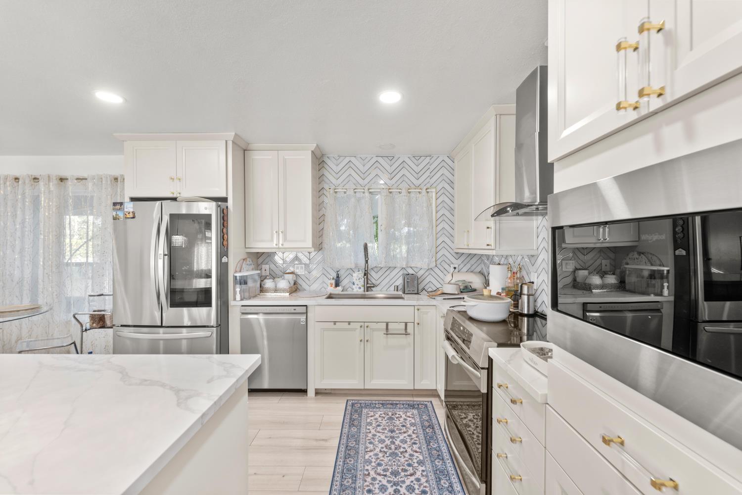 8850 Bader Road Elk Grove, CA 95624 - Photo 16 of 43 a kitchen with a stove a sink and a refrigerator