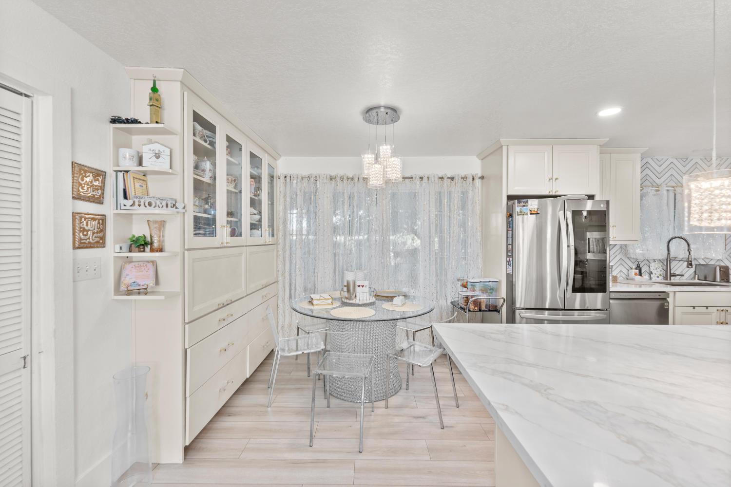 8850 Bader Road Elk Grove, CA 95624 - Photo 19 of 43 a dining room with stainless steel appliances kitchen island a table and chairs
