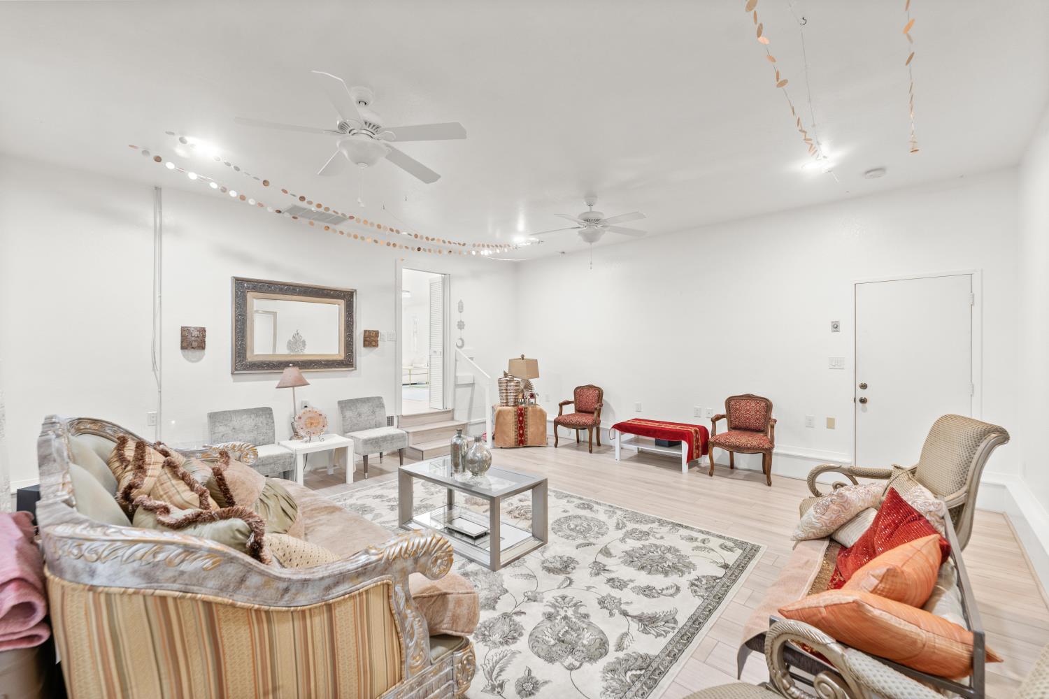 8850 Bader Road Elk Grove, CA 95624 - Photo 21 of 43 a living room with furniture and a chandelier