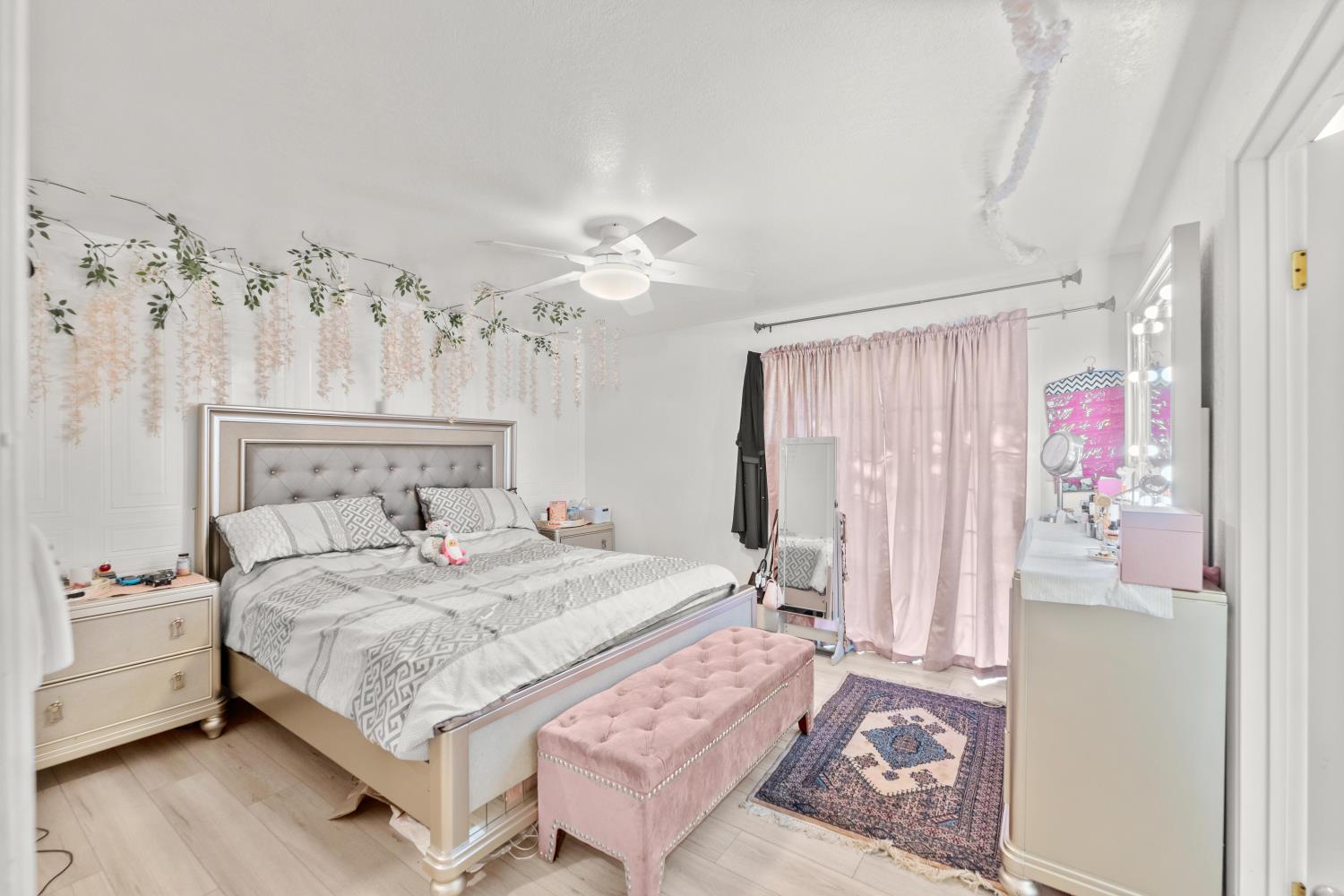 8850 Bader Road Elk Grove, CA 95624 - Photo 23 of 43 a bedroom with a bed and a chandelier