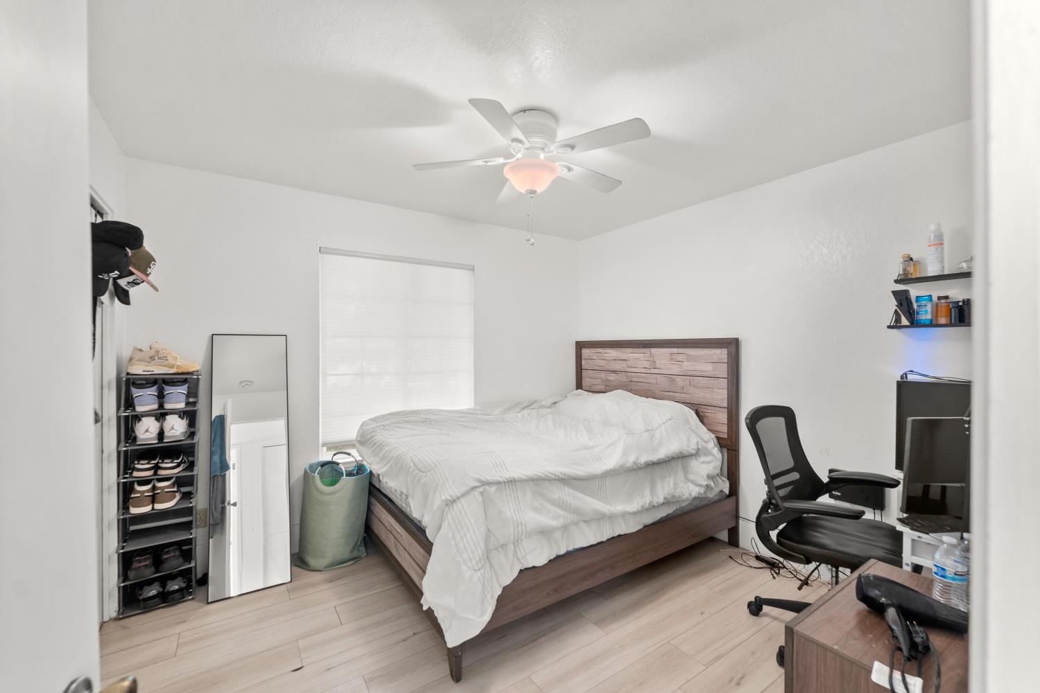 8850 Bader Road Elk Grove, CA 95624 - Photo 27 of 43 a bedroom with a bed and a chandelier