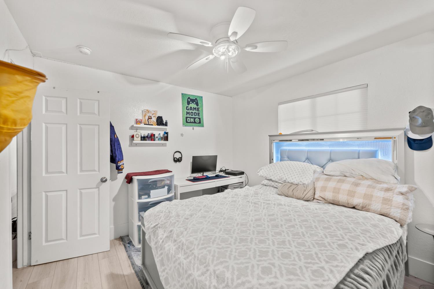 8850 Bader Road Elk Grove, CA 95624 - Photo 30 of 43 a bedroom with a bed and a chandelier