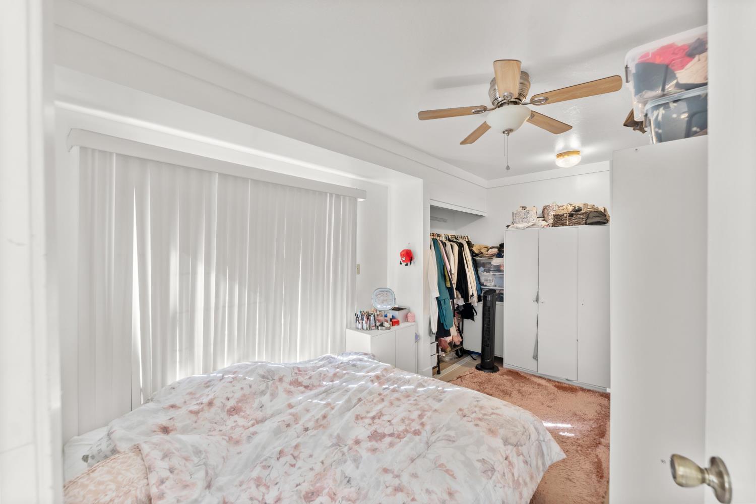 8850 Bader Road Elk Grove, CA 95624 - Photo 31 of 43 a bedroom with a bed and a chandelier