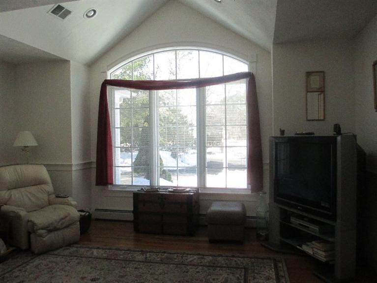 27 Forest Hills Road Cotuit, MA 02635 - Photo 12 of 28 a living room with furniture and a large window