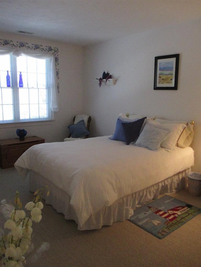 27 Forest Hills Road Cotuit, MA 02635 - Photo 21 of 28 a bedroom with a bed and window