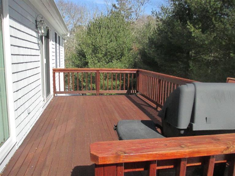 27 Forest Hills Road Cotuit, MA 02635 - Photo 23 of 28 a view of balcony with wooden floor and outdoor seating