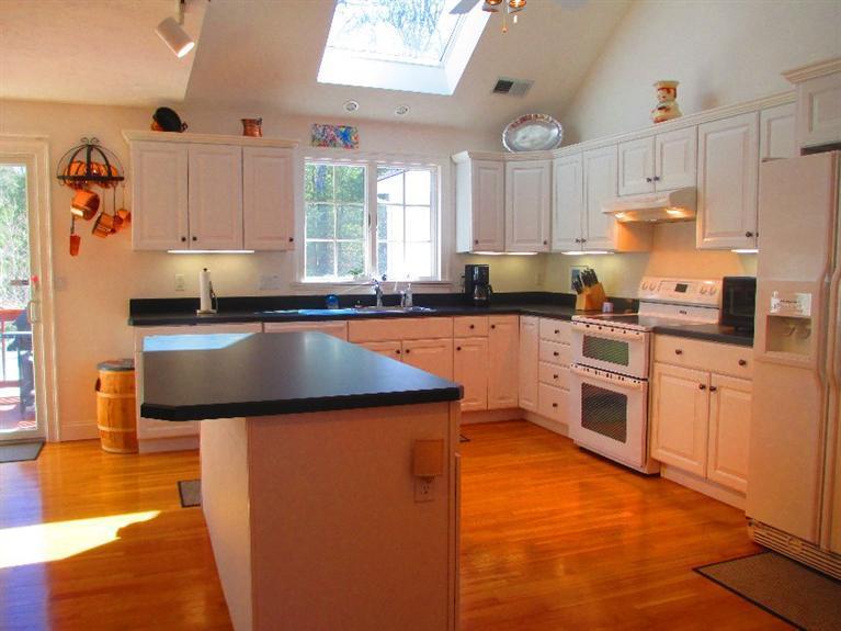 27 Forest Hills Road Cotuit, MA 02635 - Photo 6 of 28 a kitchen with stainless steel appliances granite countertop a sink stove and refrigerator