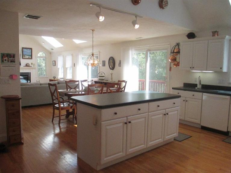 27 Forest Hills Road Cotuit, MA 02635 - Photo 8 of 28 a kitchen with granite countertop a sink cabinets and wooden floor