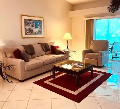 a living room with furniture and a large window