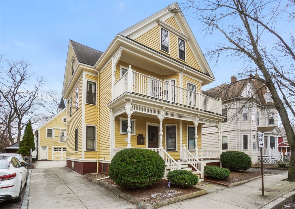 a front view of a building and car parked