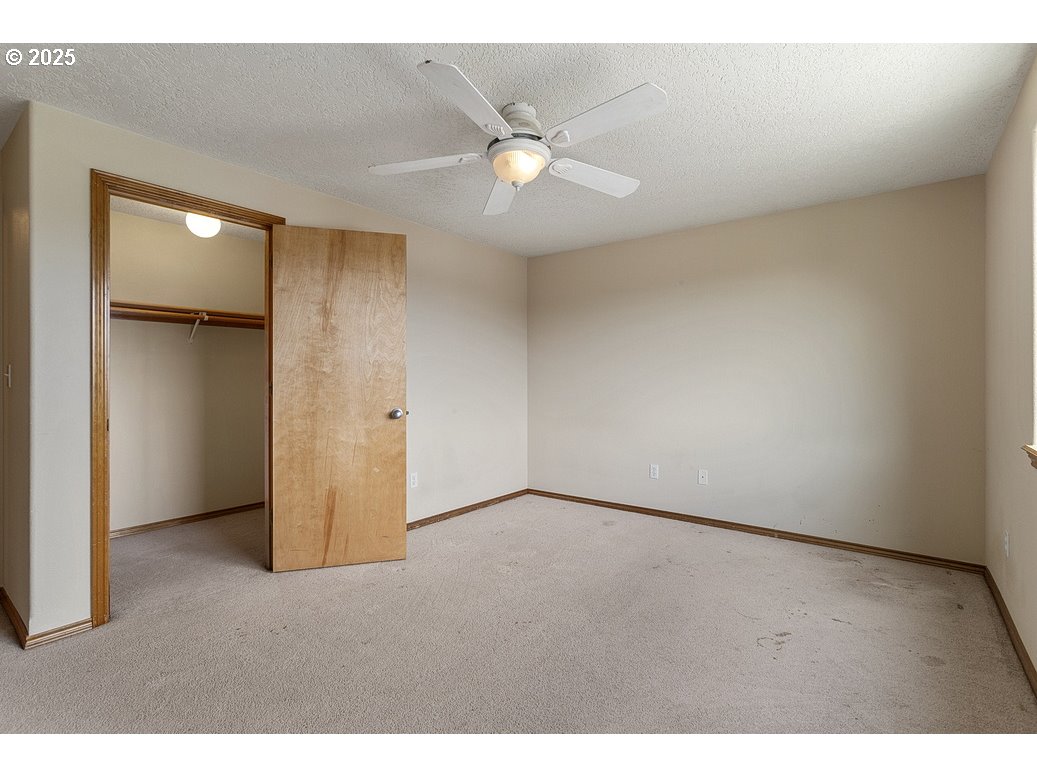 3021 Southeast Pheasant Avenue Gresham, OR 97080 - Photo 13 of 26 a view of an empty room with a ceiling fan