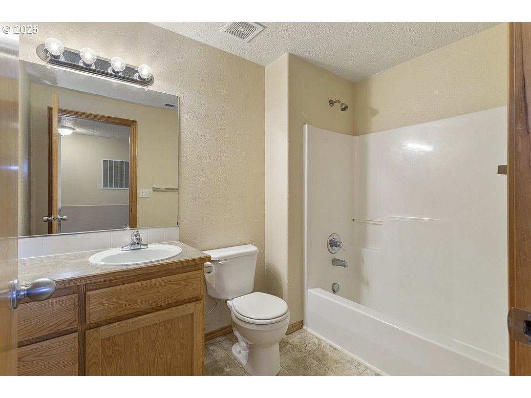 3021 Southeast Pheasant Avenue Gresham, OR 97080 - Photo 15 of 26 a bathroom with a toilet a sink and mirror