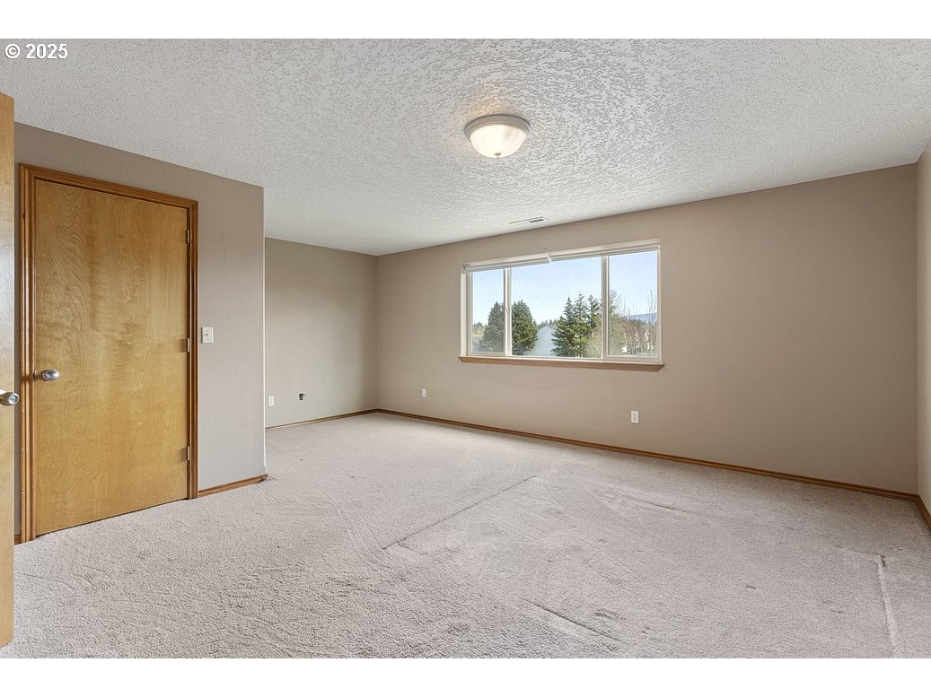 3021 Southeast Pheasant Avenue Gresham, OR 97080 - Photo 19 of 26 a view of an empty room with a window