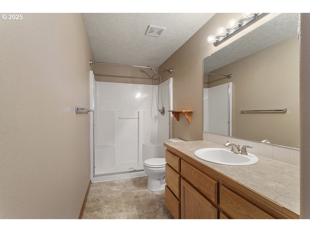 3021 Southeast Pheasant Avenue Gresham, OR 97080 - Photo 20 of 26 a bathroom with a sink a toilet a shower and a mirror