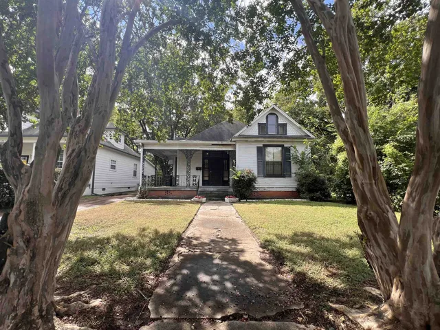 a front view of a house with yard patio and swimming pool