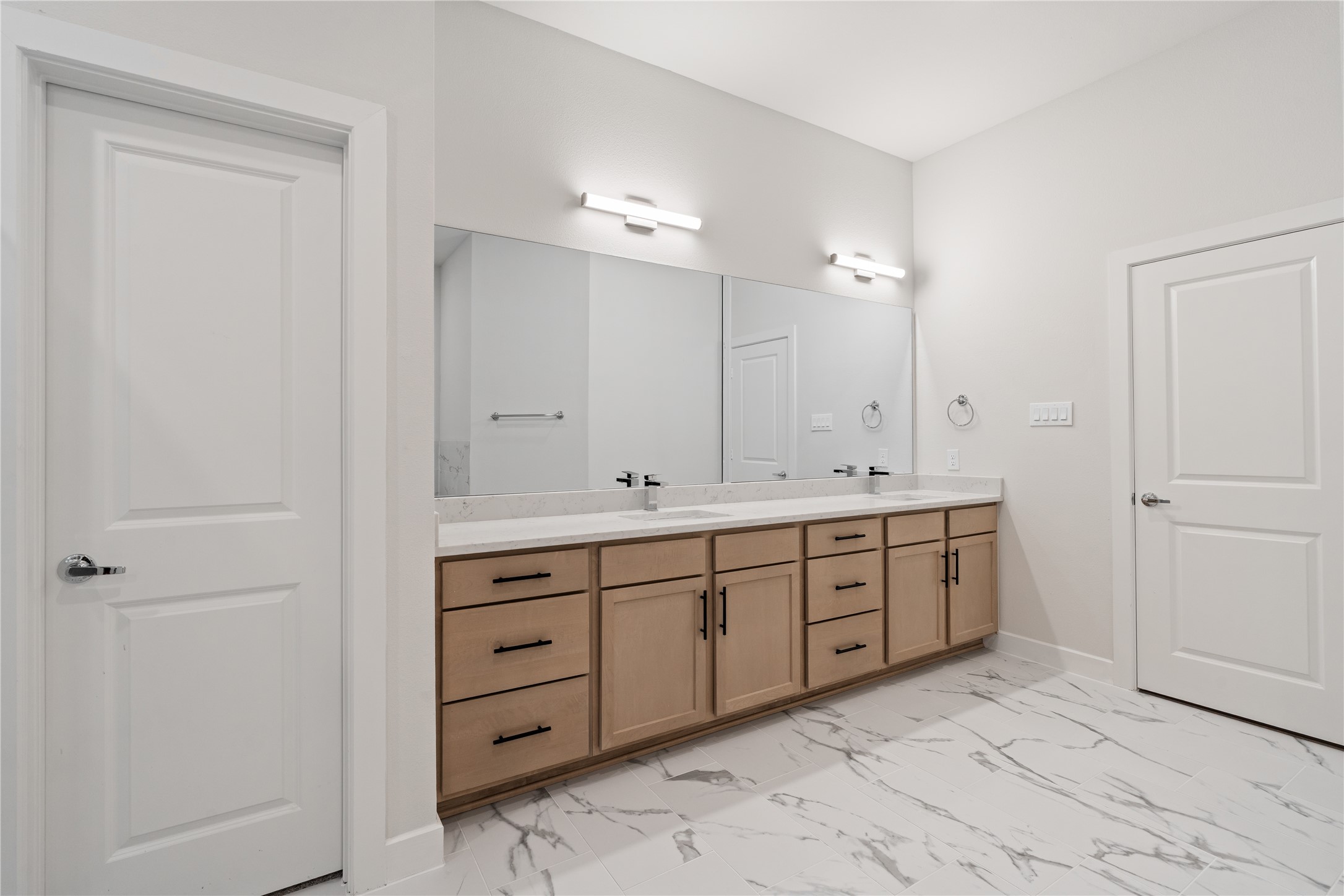 6451 Rena Street Houston, TX 77092 - Photo 23 of 33 Natural wood cabinetry and quartz surfaces keep the design warm and modern while maintaining a clean, uncluttered feel.