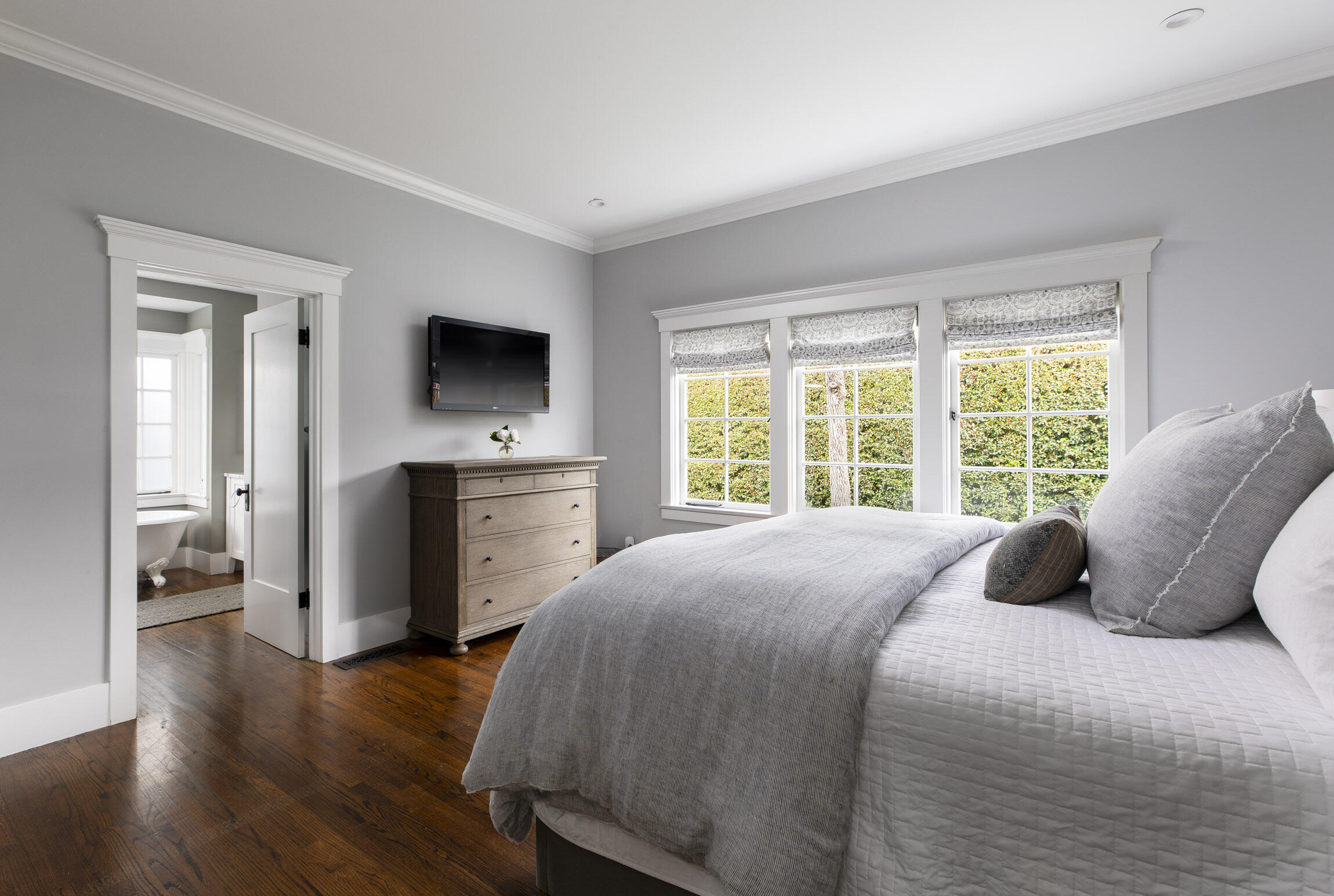 199 Ocean View Avenue Carpinteria, CA 93013 - Photo 11 of 22 a bedroom with a bed and a flat tv screen on dresser