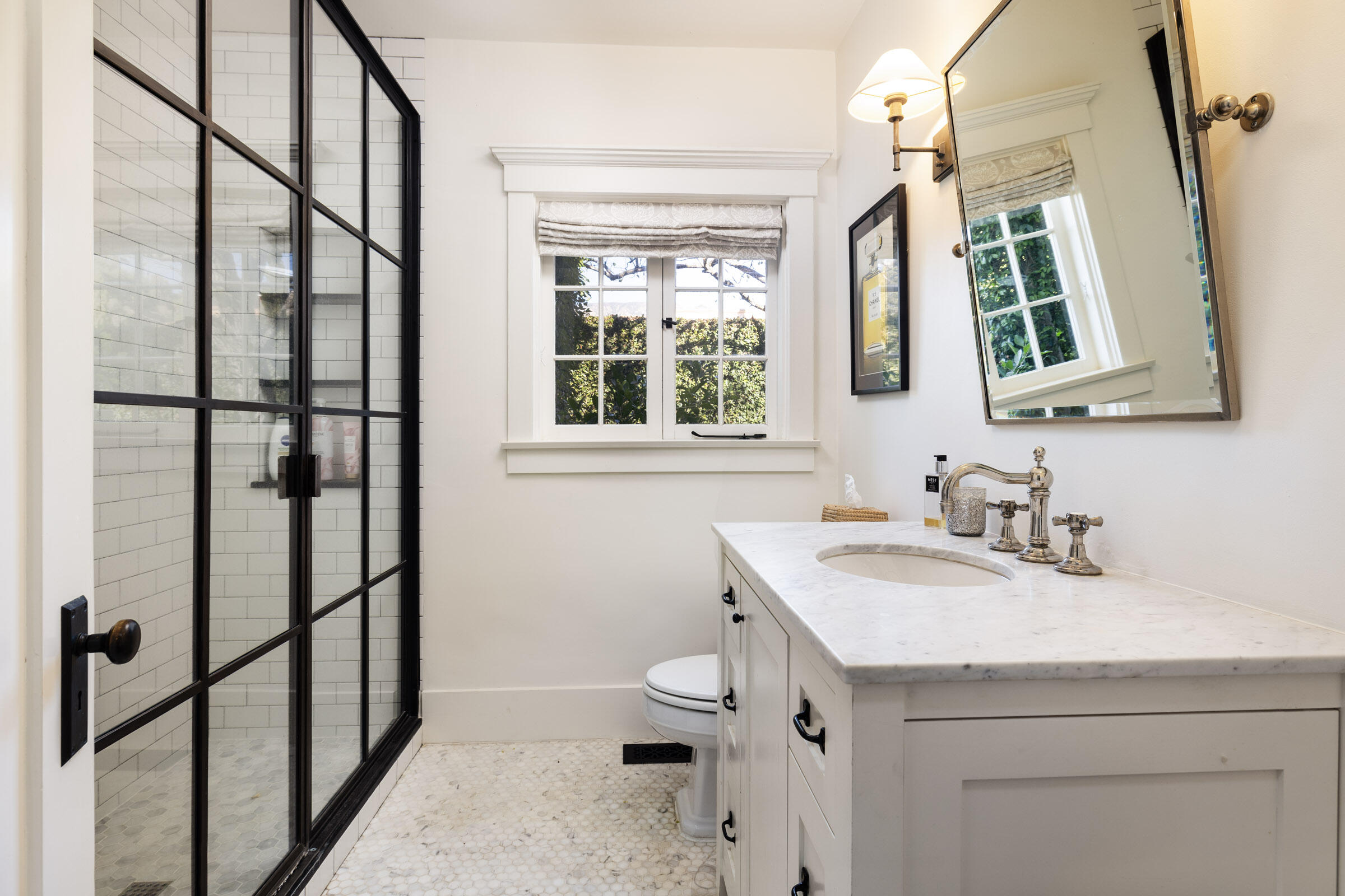 199 Ocean View Avenue Carpinteria, CA 93013 - Photo 16 of 22 a bathroom with a sink a toilet and a window