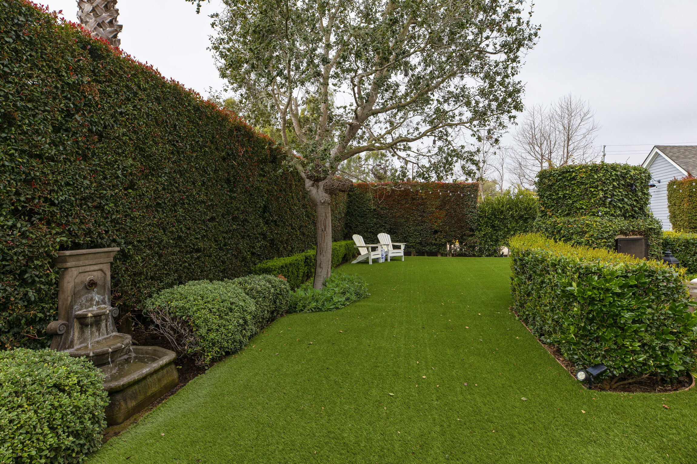199 Ocean View Avenue Carpinteria, CA 93013 - Photo 19 of 22 a view of a garden with plants and a bench