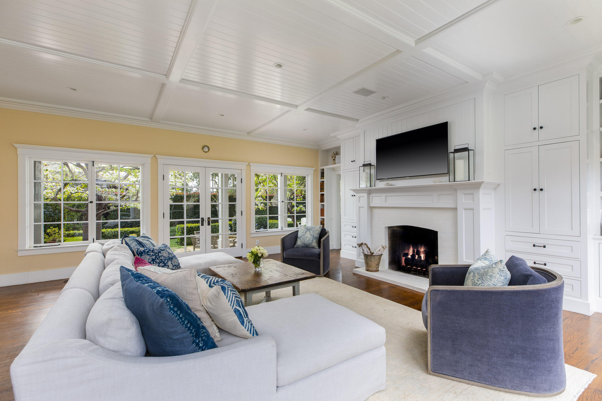 199 Ocean View Avenue Carpinteria, CA 93013 - Photo 10 of 22 a living room with furniture a fireplace and a flat screen tv