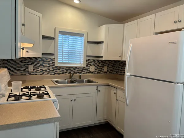 a white refrigerator freezer sitting inside of a kitchen