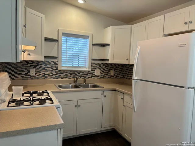 a white refrigerator freezer sitting inside of a kitchen