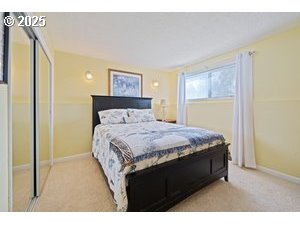 845 Northwest 3rd Street Gresham, OR 97030 - Photo 18 of 32 a bedroom with a bed and a painting on the wall