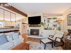 845 Northwest 3rd Street Gresham, OR 97030 - Photo 9 of 32 a living room with furniture a flat screen tv and a fireplace