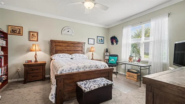 a bedroom with a bed a bookshelf a desk and chair with the wooden floor