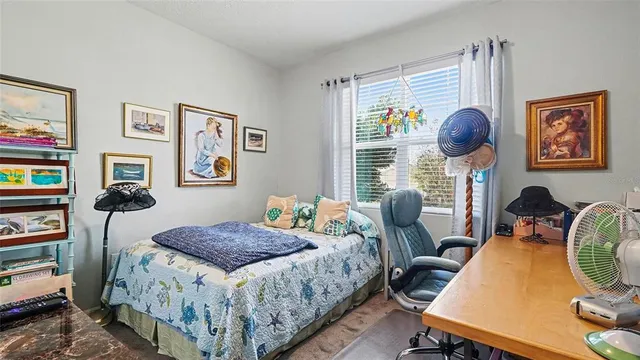 a bedroom with a bed window and a flat screen tv
