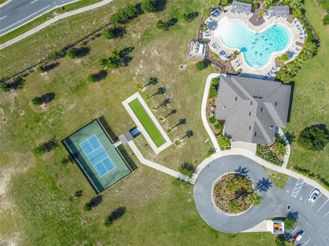 an aerial view of a house with a swimming pool and outdoor seating