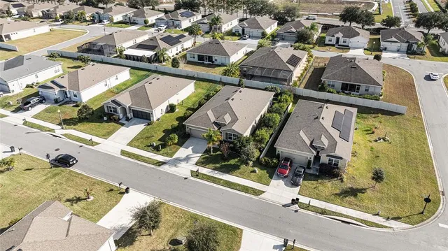 an aerial view of a house with a yard